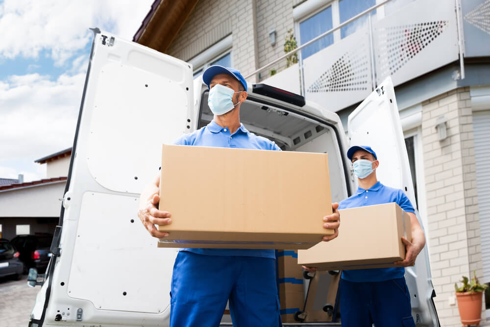 Movers Carefully Loading Box Into Moving Truck Pacific Palisades